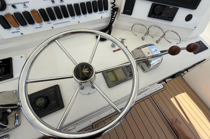 Slide: The Image of Steering wheel and controls of a 1986 Bertram 46 Convertible yacht. - 79