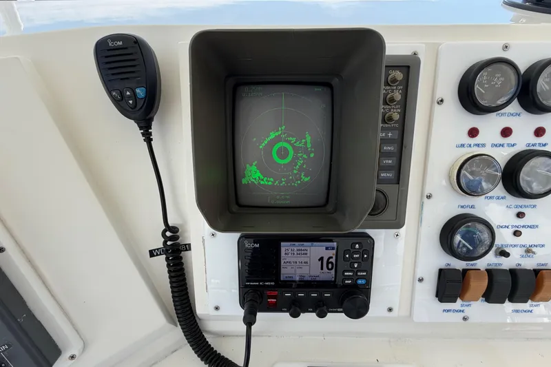 Slide: The Image of Control panel of a 1986 Bertram 46 Convertible boat with radar and communication equipment. - 80