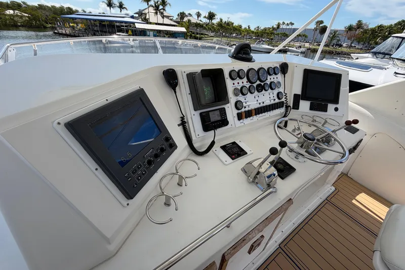 Slide: The Image of Helm of 1986 Bertram 46 Convertible yacht with navigation equipment and steering wheel. - 82