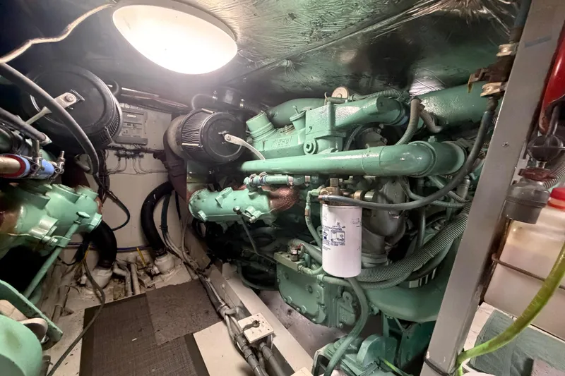 Slide: The Image of Engine room of a 1986 Bertram 46 Convertible yacht, showcasing mechanical components. - 87