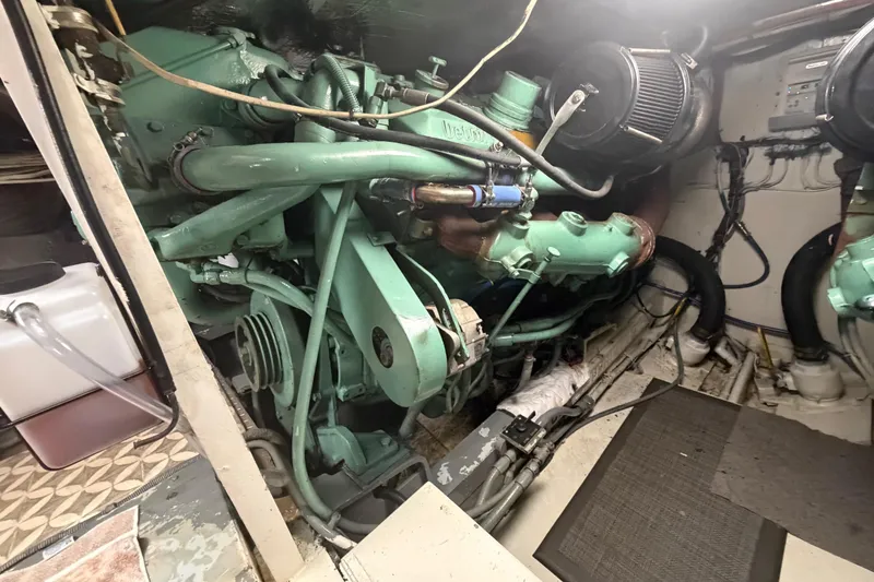 Slide: The Image of Engine room of a 1986 Bertram 46 Convertible boat, showcasing mechanical components. - 89