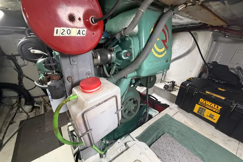 Slide: The Image of Engine room of a 1986 Bertram 46 Convertible with visible machinery and tools. - 90