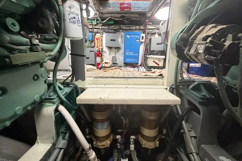 Slide: The Image of Engine room of a 1986 Bertram 46 Convertible boat, showcasing mechanical components and wiring. - 91