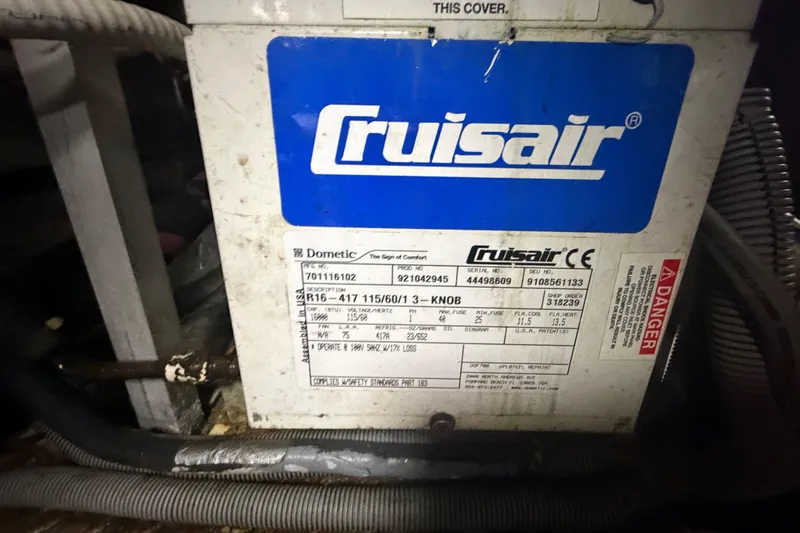 Slide: The Image of Cruisair unit label on a 1986 Bertram 46 Convertible boat, showing specifications and warnings. - 95