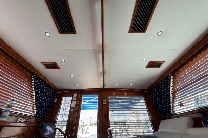 Slide: The Image of Interior of 1986 Bertram 46 Convertible yacht with wooden blinds and modern lighting. - 96