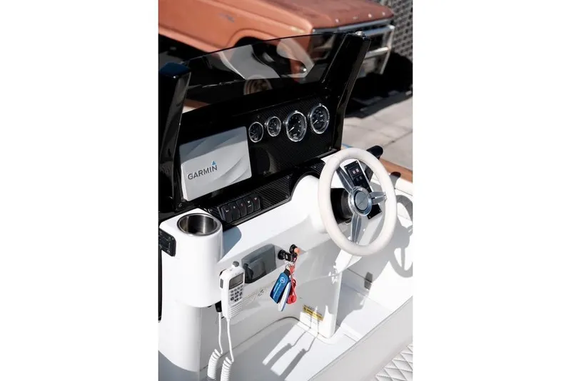 Slide: The Image of Carbon Craft CC130 boat dashboard with Garmin display and steering wheel, 2018 model. - 4
