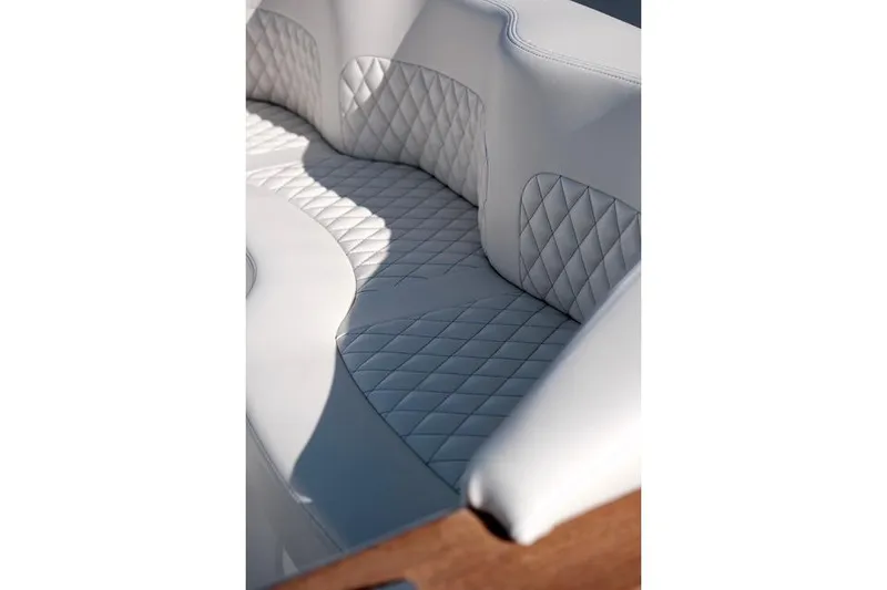 Slide: The Image of Luxurious white quilted seating in 2018 Carbon Craft CC130 boat interior. - 5