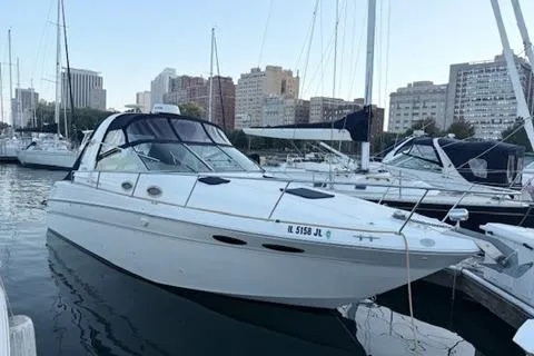 The Image of 1999 Sea Ray 290 Sundancer docked in urban marina setting. - 0