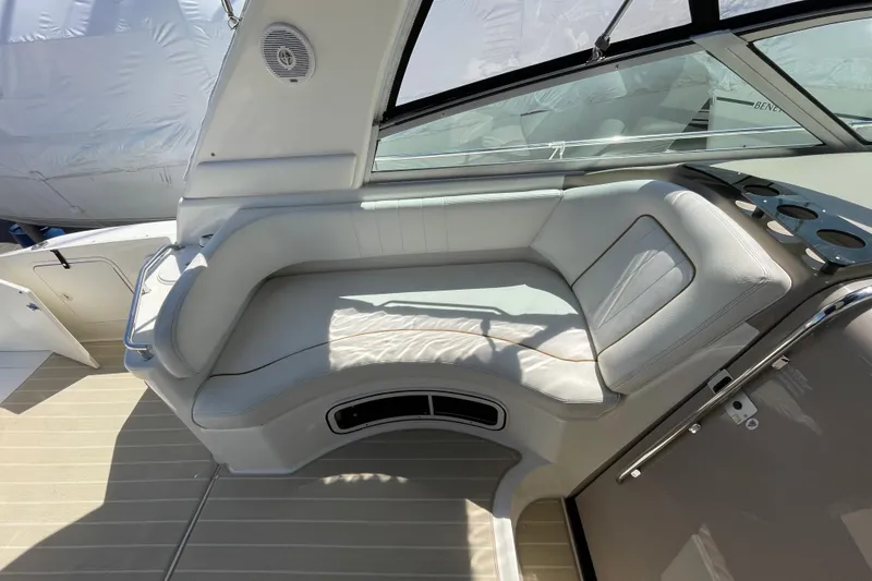 Slide: The Image of 1999 Sea Ray 290 Sundancer boat interior with white leather seating and cup holders. - 11