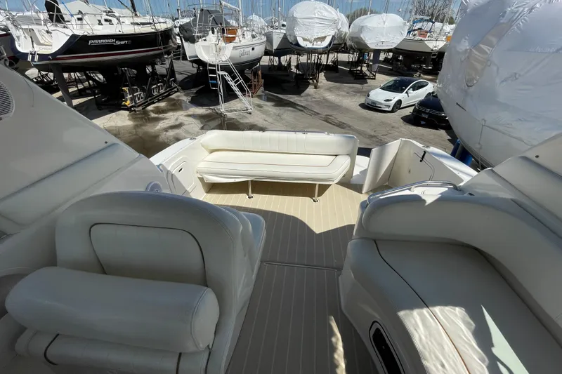 Slide: The Image of 1999 Sea Ray 290 Sundancer helm with gauges, steering wheel, and control panel. - 14