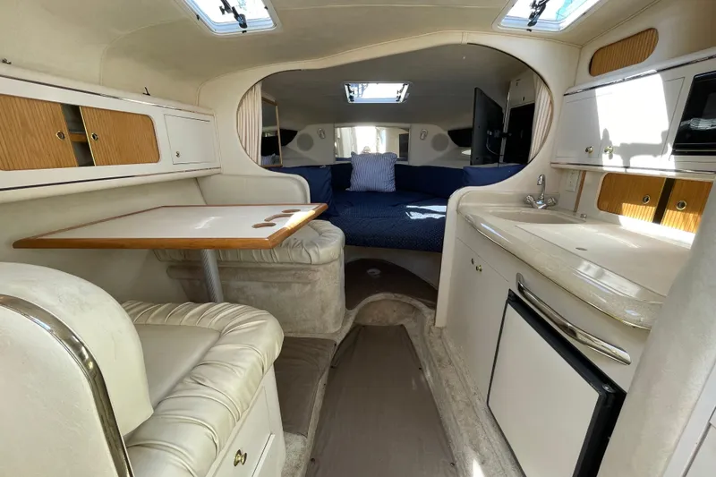 Slide: The Image of 1999 Sea Ray 290 Sundancer helm covered with a blue protective cloth. - 17