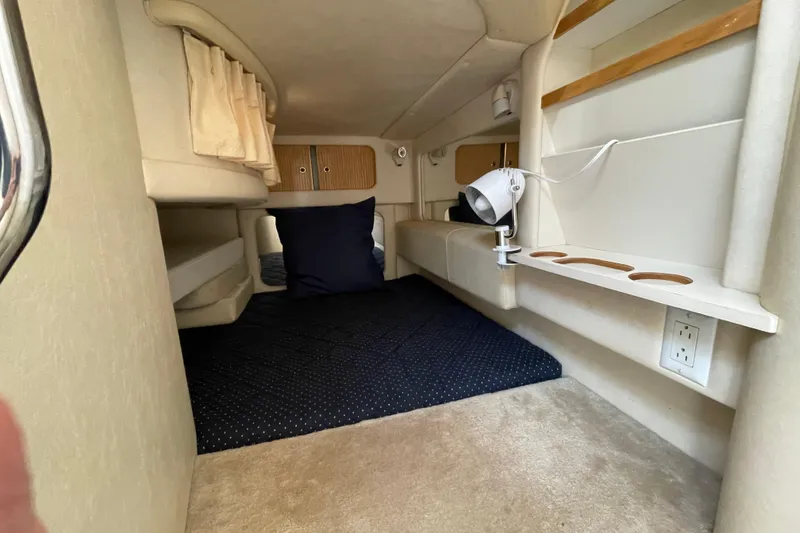 Slide: The Image of Interior of 1999 Sea Ray 290 Sundancer boat with seating and table. - 27