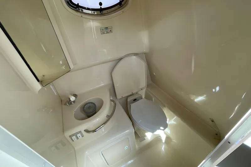 Slide: The Image of Interior of 1999 Sea Ray 290 Sundancer with seating, table, and cushions. - 28