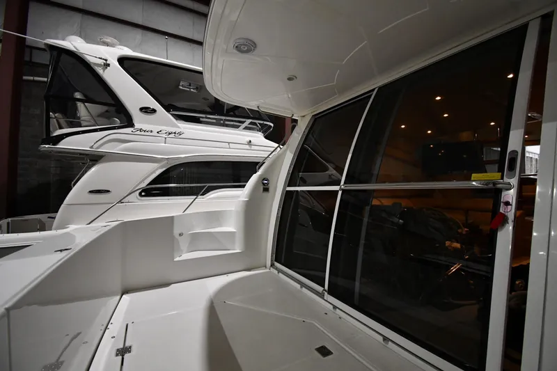 Slide: The Image of 2003 Cruisers Yachts 5000 Sedan Sport in a marina, showcasing sleek design and luxury interior. - 13
