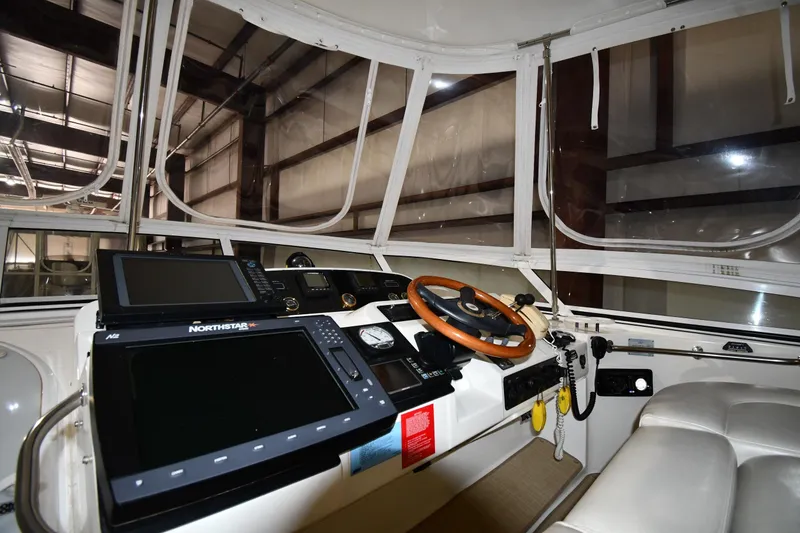 Slide: The Image of Interior helm of 2003 Cruisers Yachts 5000 Sedan Sport with navigation equipment and leather seating. - 18