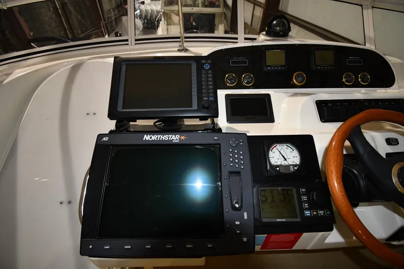 Slide: The Image of Control panel of 2003 Cruisers Yachts 5000 Sedan Sport with navigation equipment and gauges. - 19