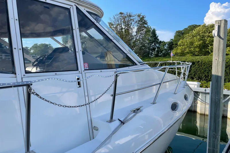 Slide: The Image of 2003 Cruisers Yachts 5000 Sedan Sport docked, showcasing sleek design and polished exterior. - 2