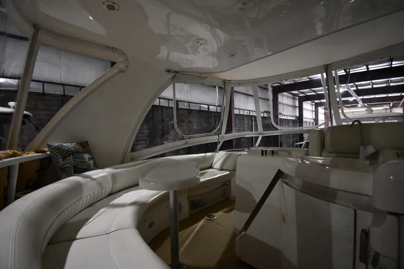 Slide: The Image of Interior of 2003 Cruisers Yachts 5000 Sedan Sport with white seating and modern design. - 24