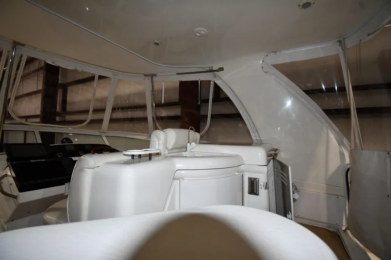 Slide: The Image of Interior of 2003 Cruisers Yachts 5000 Sedan Sport, featuring white seating and helm area. - 25