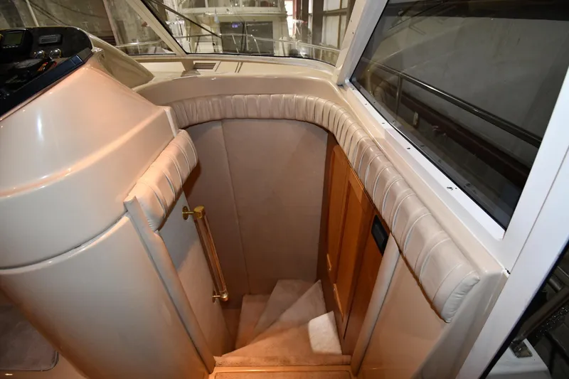 Slide: The Image of Interior staircase of 2003 Cruisers Yachts 5000 Sedan Sport, featuring plush upholstery. - 30