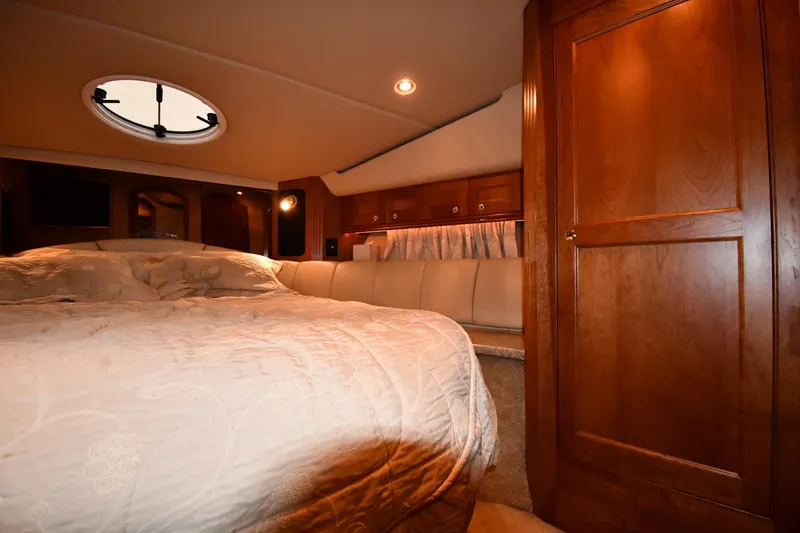 Slide: The Image of Luxurious cabin interior of 2003 Cruisers Yachts 5000 Sedan Sport with wood finishes. - 34