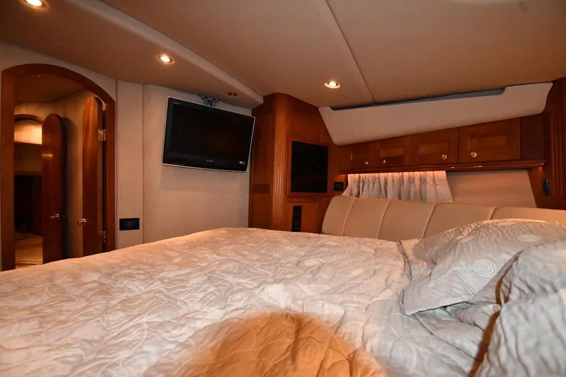 Slide: The Image of Luxurious bedroom interior of 2003 Cruisers Yachts 5000 Sedan Sport with TV and wood accents. - 36