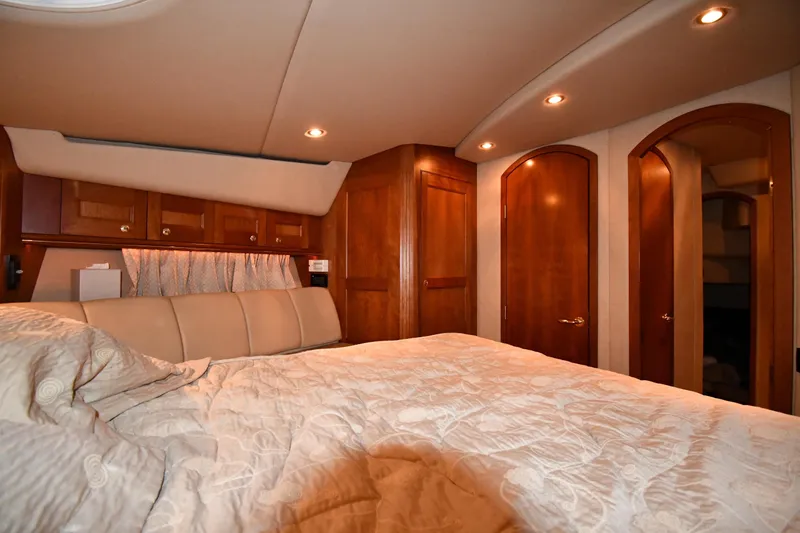 Slide: The Image of Luxurious bedroom interior of 2003 Cruisers Yachts 5000 Sedan Sport with wood accents. - 37