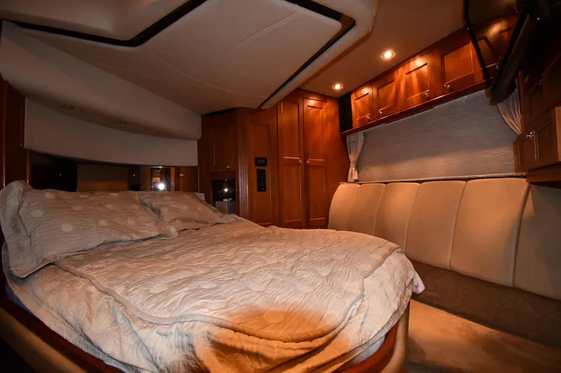 Slide: The Image of Luxurious bedroom interior of 2003 Cruisers Yachts 5000 Sedan Sport with elegant wood cabinetry. - 43