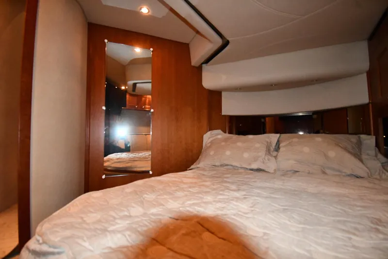 Slide: The Image of Luxurious bedroom interior of 2003 Cruisers Yachts 5000 Sedan Sport with cozy bedding. - 44