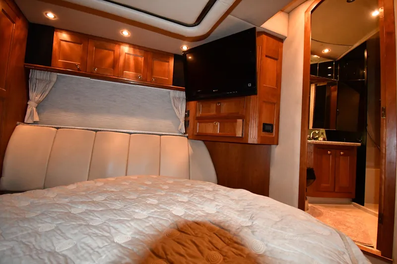 Slide: The Image of Luxurious cabin interior of 2003 Cruisers Yachts 5000 Sedan Sport with wood cabinetry. - 46