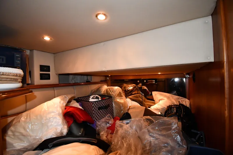 Slide: The Image of Interior cabin of 2003 Cruisers Yachts 5000 Sedan Sport, cluttered with various items. - 50