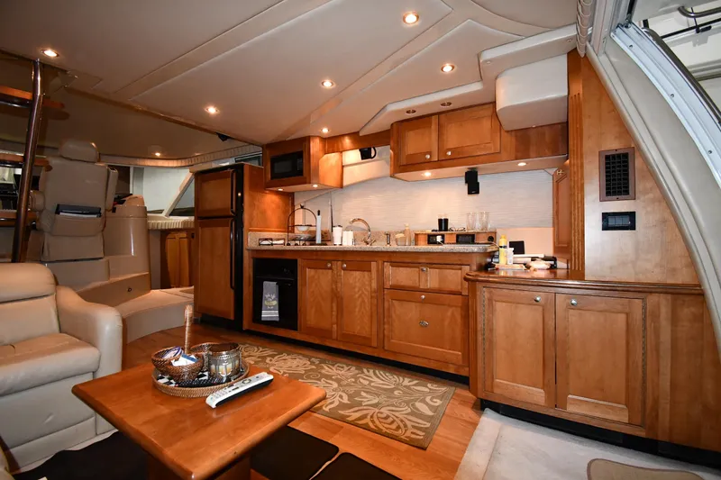 Slide: The Image of Luxurious interior of 2003 Cruisers Yachts 5000 Sedan Sport with wooden cabinetry and modern amenities. - 51