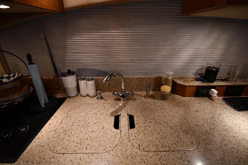 Slide: The Image of 2003 Cruisers Yachts 5000 Sedan Sport kitchen with granite countertop and modern sink fixtures. - 55