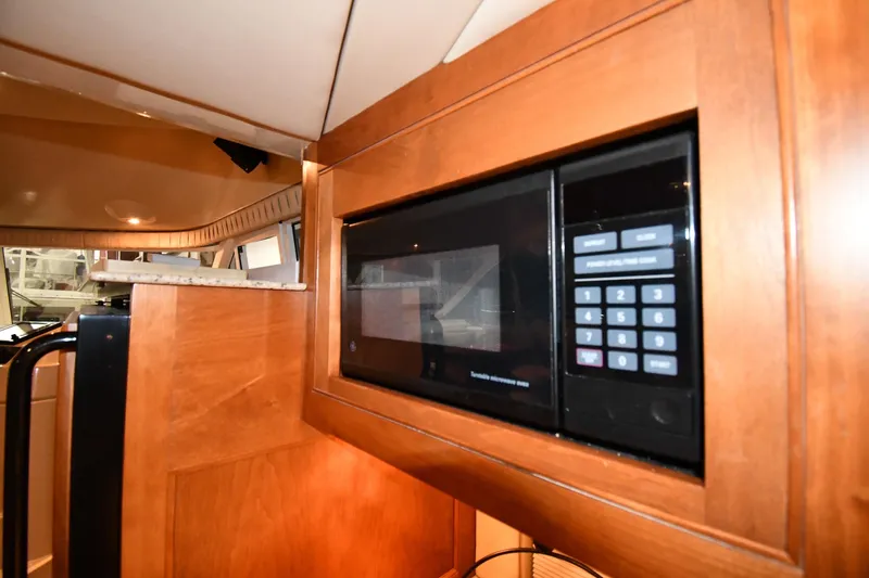 Slide: The Image of 2003 Cruisers Yachts 5000 Sedan Sport interior with built-in microwave oven. - 57