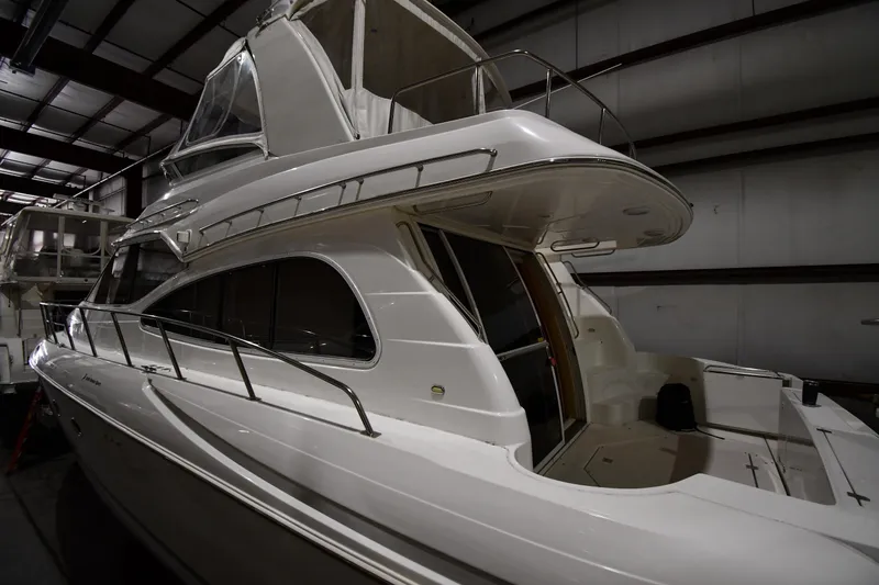 Slide: The Image of 2003 Cruisers Yachts 5000 Sedan Sport in indoor storage, side view. - 6