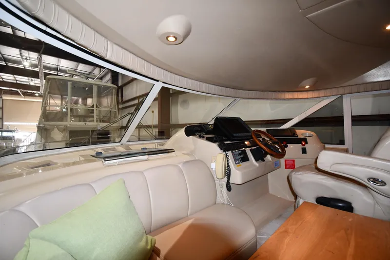 Slide: The Image of Interior of 2003 Cruisers Yachts 5000 Sedan Sport, featuring helm and seating area. - 60