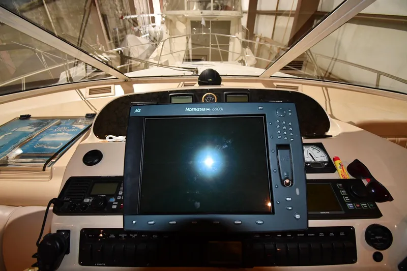 Slide: The Image of Dashboard of a 2003 Cruisers Yachts 5000 Sedan Sport with navigation equipment. - 62