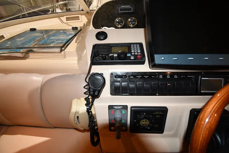 Slide: The Image of 2003 Cruisers Yachts 5000 Sedan Sport helm with navigation controls and communication equipment. - 63