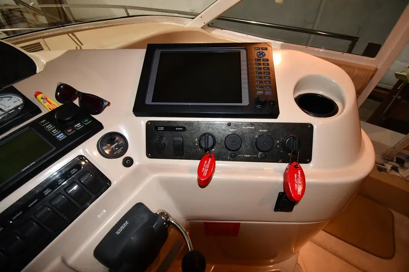 Slide: The Image of Control panel of a 2003 Cruisers Yachts 5000 Sedan Sport with navigation equipment. - 65