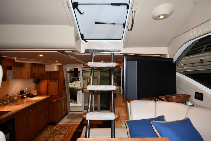 Slide: The Image of Interior of 2003 Cruisers Yachts 5000 Sedan Sport with modern kitchen and cozy seating area. - 67