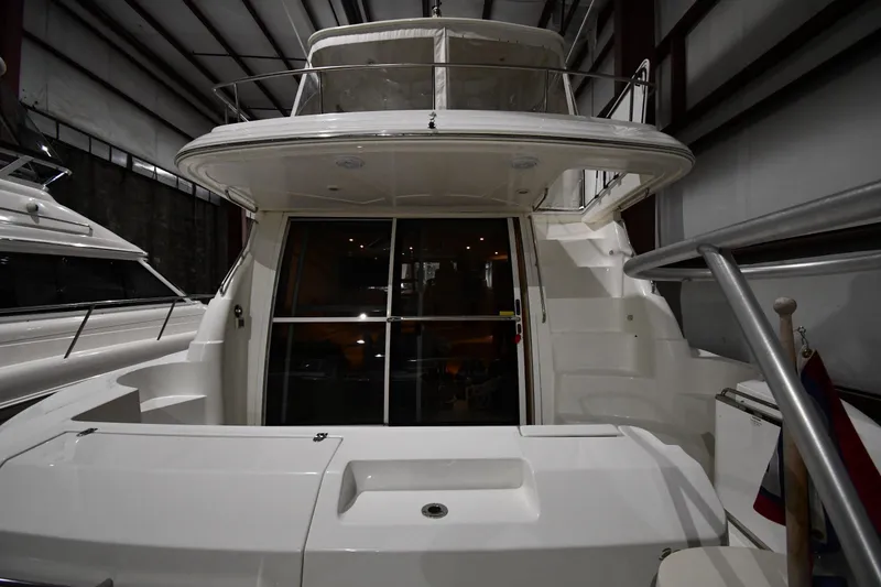 Slide: The Image of 2003 Cruisers Yachts 5000 Sedan Sport in indoor storage, rear view of deck and cabin entrance. - 7