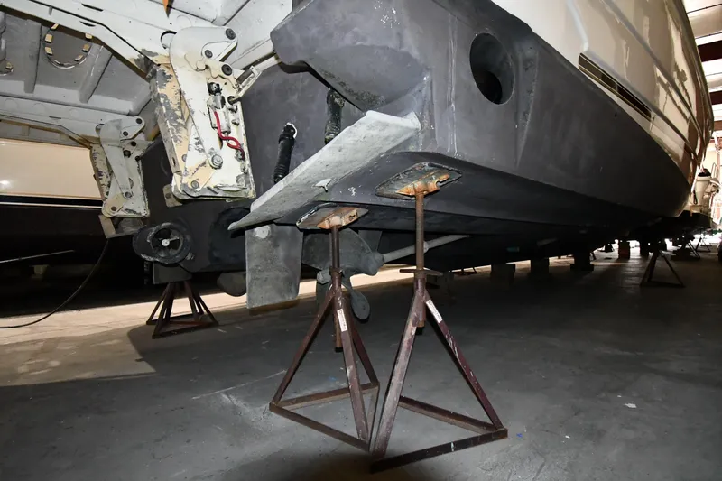 Slide: The Image of 2003 Cruisers Yachts 5000 Sedan Sport on stands in a maintenance facility. - 77