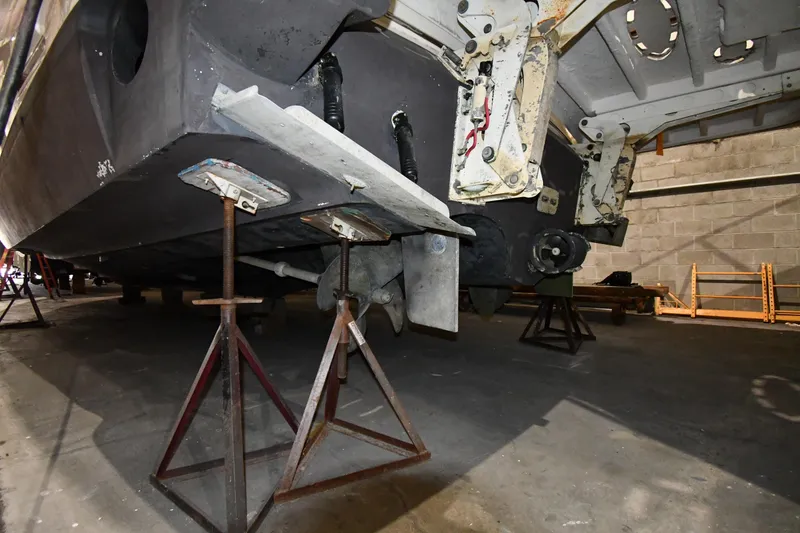 Slide: The Image of 2003 Cruisers Yachts 5000 Sedan Sport on stands in a workshop. - 78