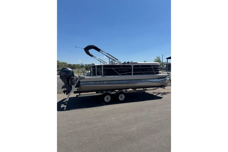 The Image of 2023 Godfrey Sweetwater 2086 SB pontoon boat on trailer, parked outdoors. - 1