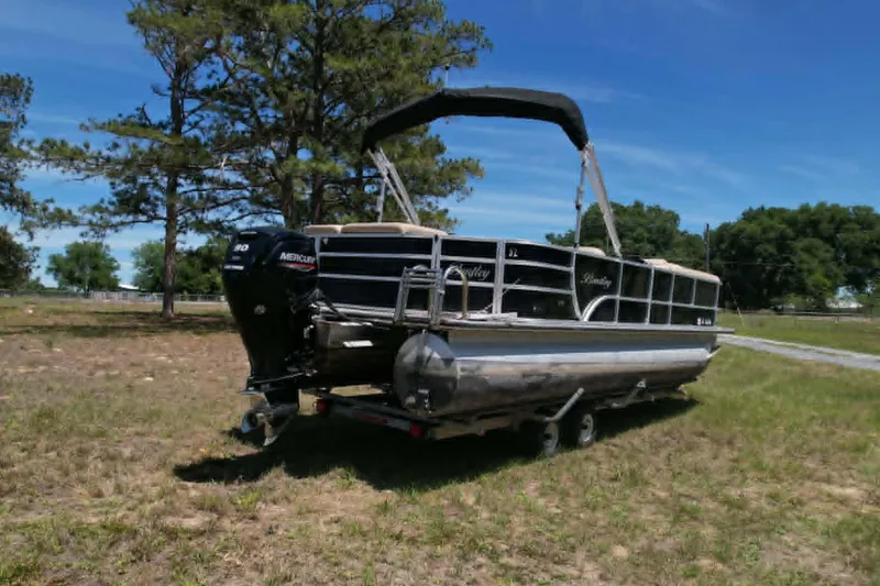 The Image of 2022 Bentley Pontoons 240 CRUISE on trailer, parked on grassy field under clear blue sky. - 0