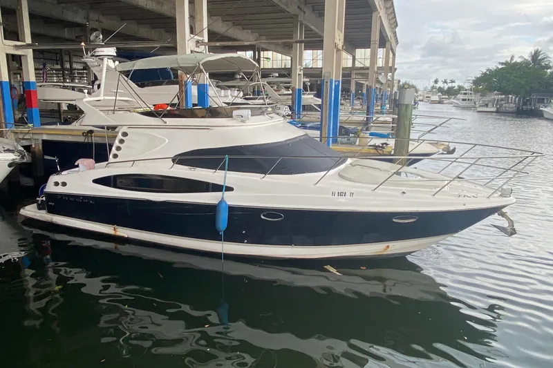 The Image of 2006 Regal Commodore 3880 yacht docked in a marina, side view. - 0