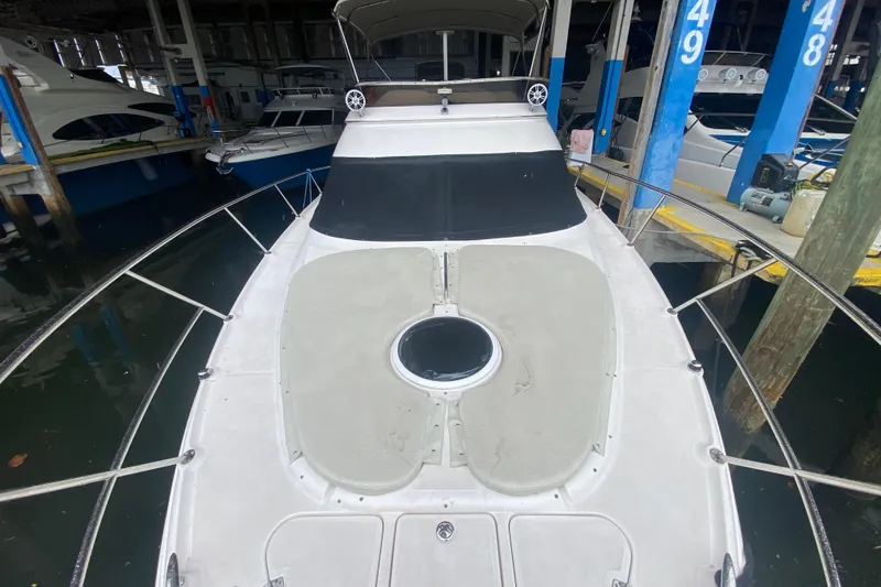 Slide: The Image of 2006 Regal Commodore 3880 yacht docked in a marina, viewed from the bow. - 10