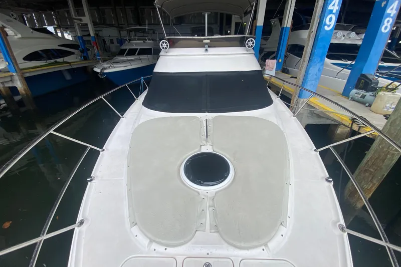 Slide: The Image of 2006 Regal Commodore 3880 yacht docked in marina, front deck view. - 11