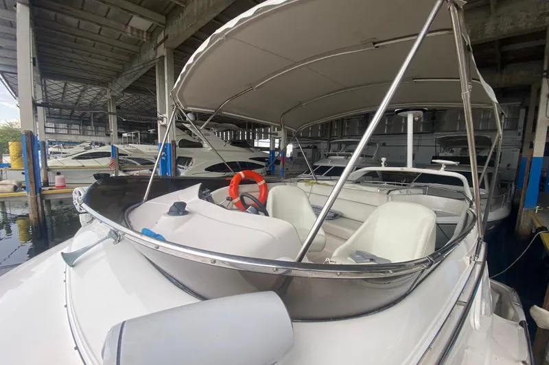 Slide: The Image of 2006 Regal Commodore 3880 boat docked in a marina under a covered structure. - 13