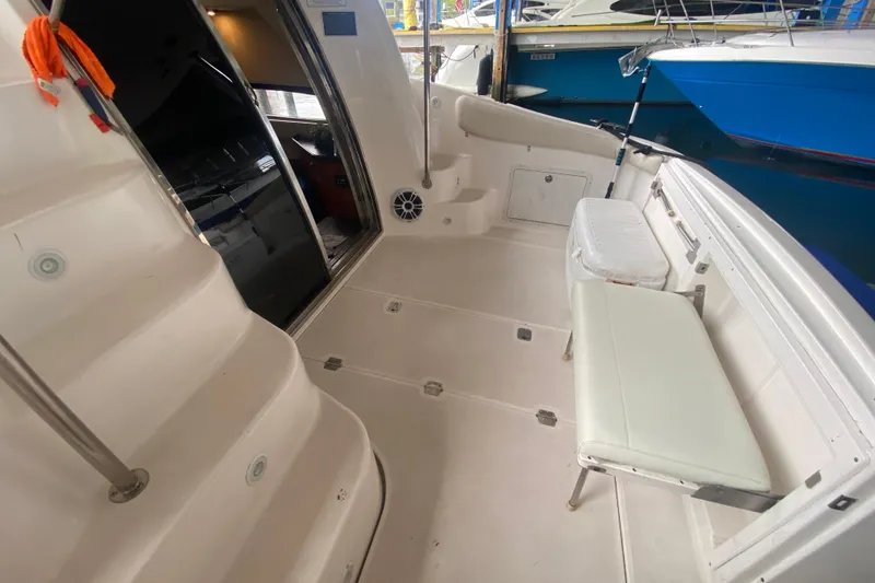 Slide: The Image of 2006 Regal Commodore 3880 yacht interior with seating and open cabin door. - 17